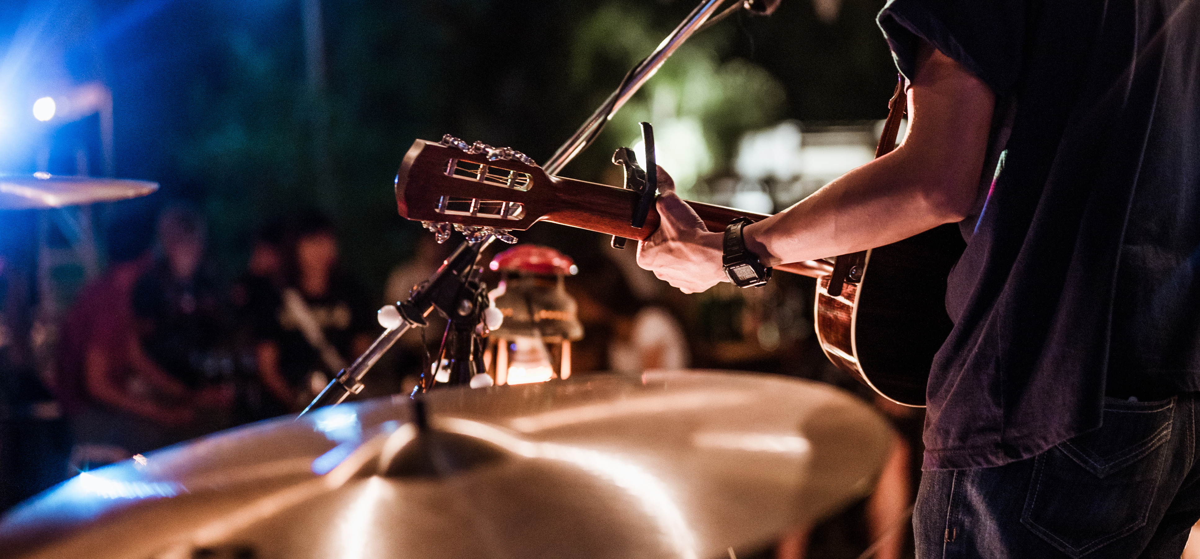 Guitarist performing live music at night