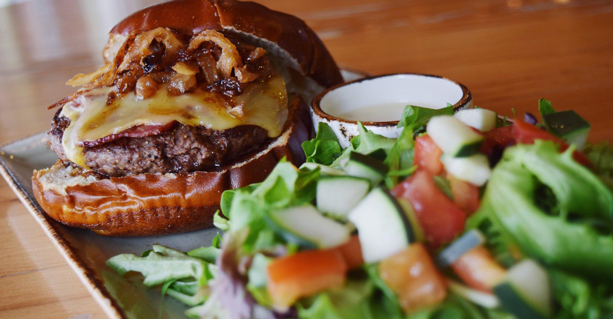 Burger with caramelized onions and a side salad